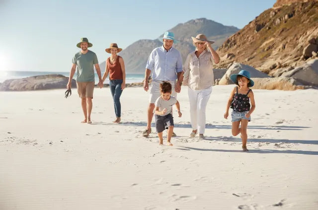How long does sunscreen last showing family walking on a beach