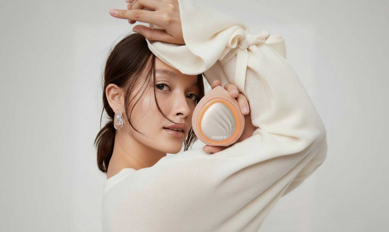 Woman holding professional LED light therapy mask to use with science-backed skincare ingredients