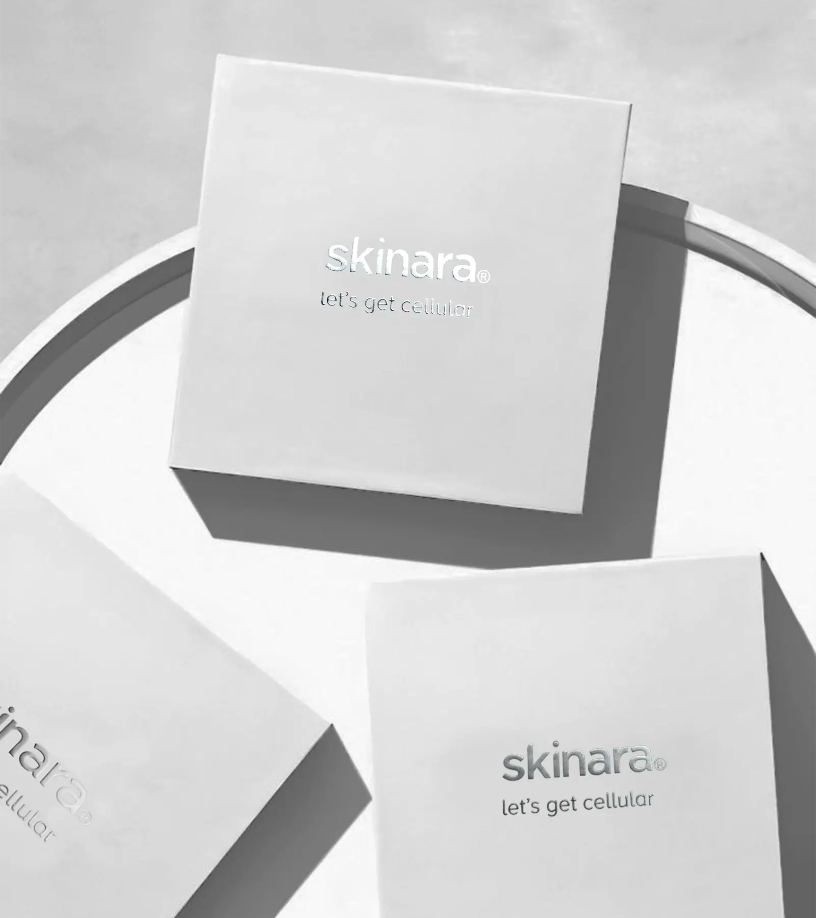 3 skinara white ampoule boxes on a white tray