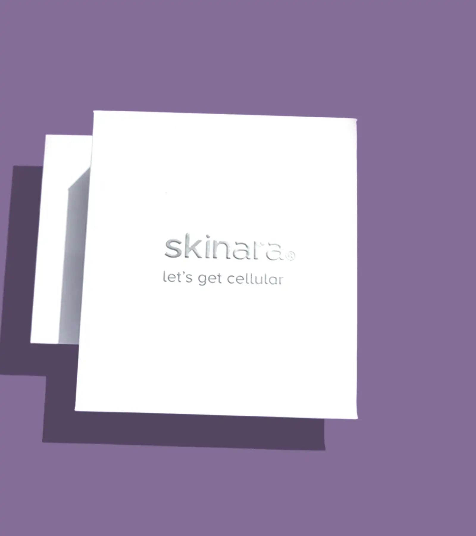 White card gift box with 'skinara' logo and 'let's get cellular' text on a purple background