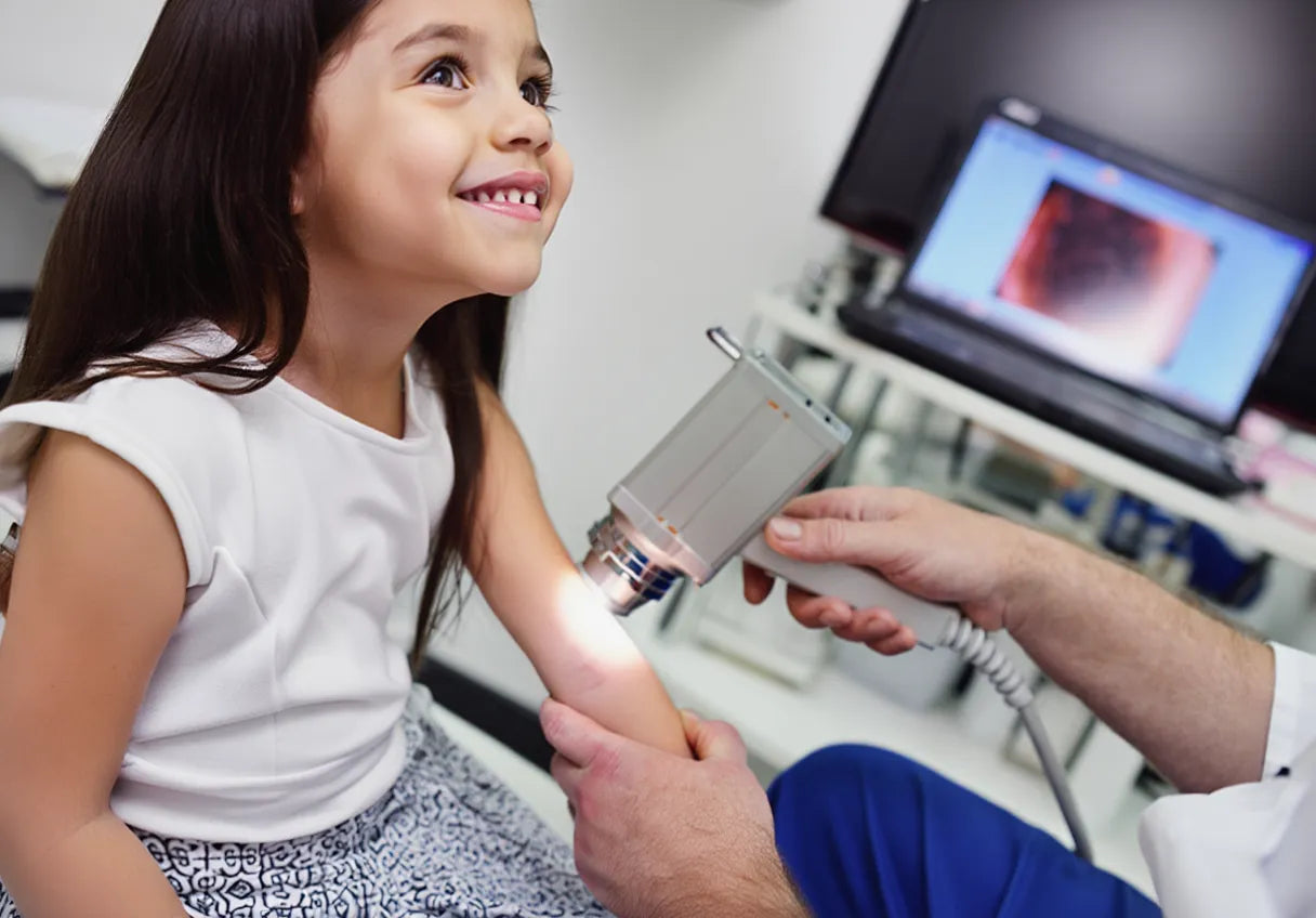 Child receiving a dermatologist examination with a dermato microscope in skinara dermatology clinic