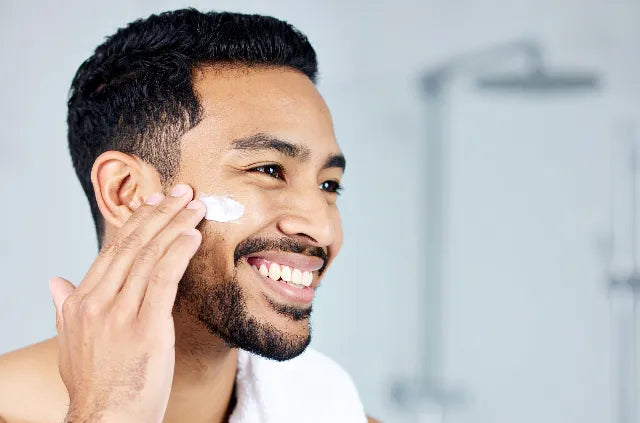 best sun cream for pigmentation showing man applying cream to his face