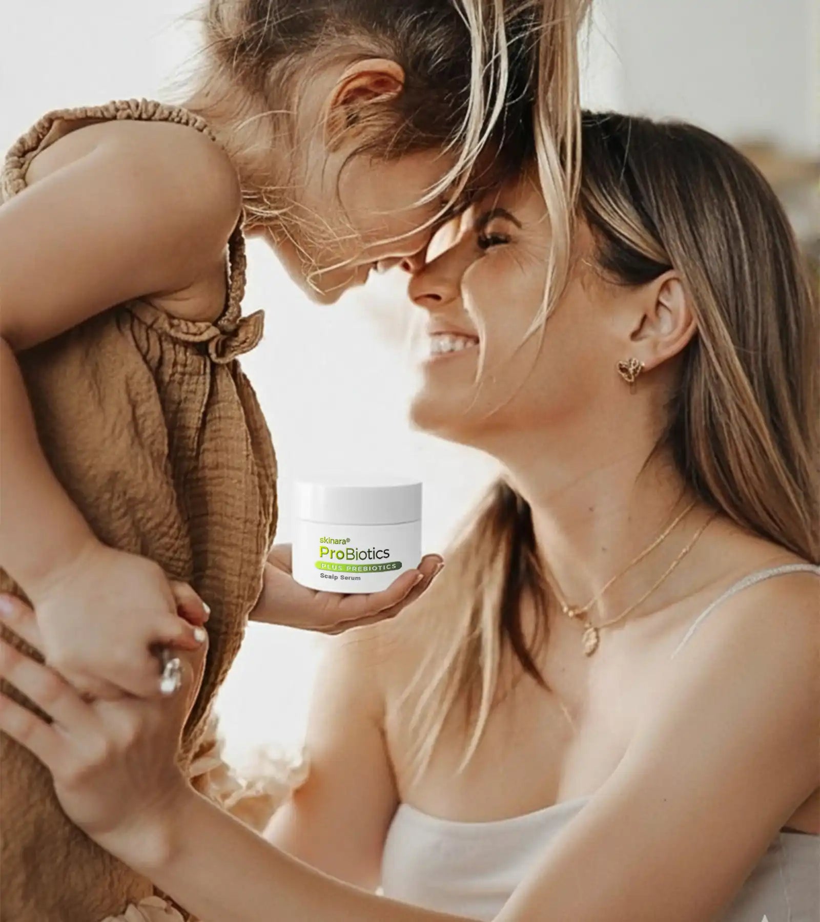 Woman holding a child and a bio serum probiotics product container, with a blurred background