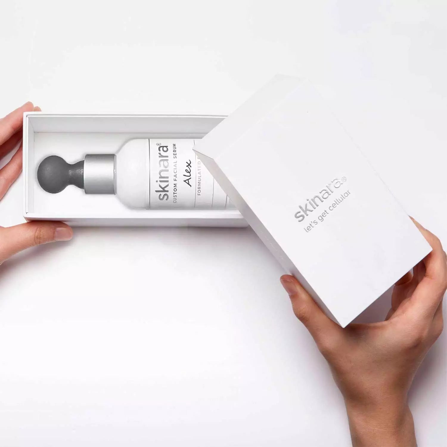 Skinara Custom Serum white box being opened on a white background