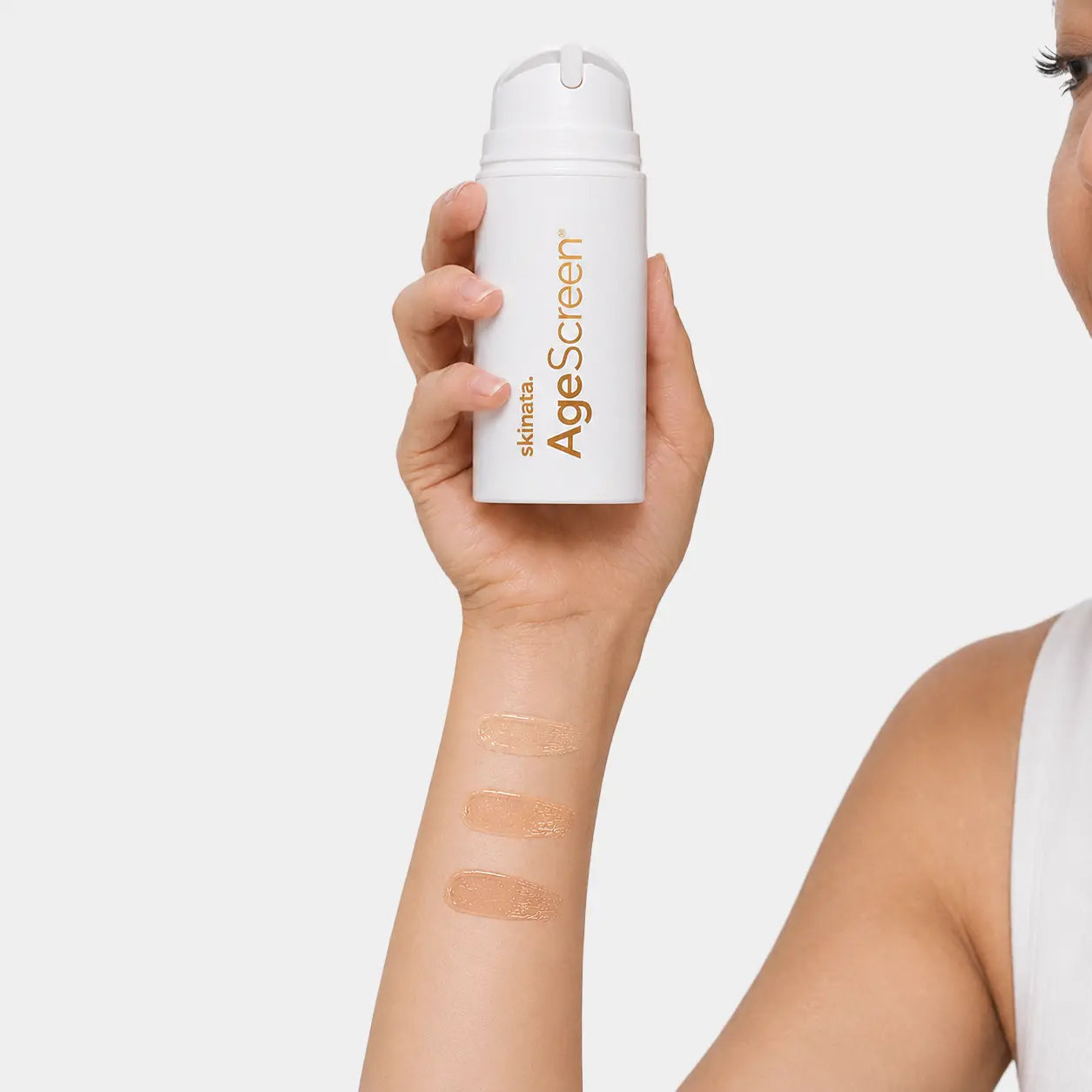 Skinara tinted AgeScreen sunscreen lotion shades on the skin: Clear, Honey Almond, Mocca and Espresso