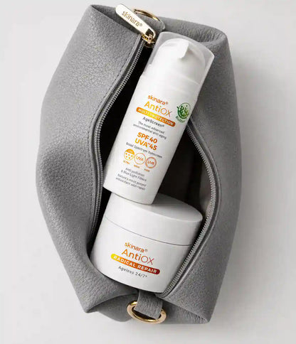 The Skinara cosmetic pouch is shown open with two skincare products, a power duo, inside: Skincare Antiox SPF 40 and a white jar labeled Skincare Antiox Radical Repair.