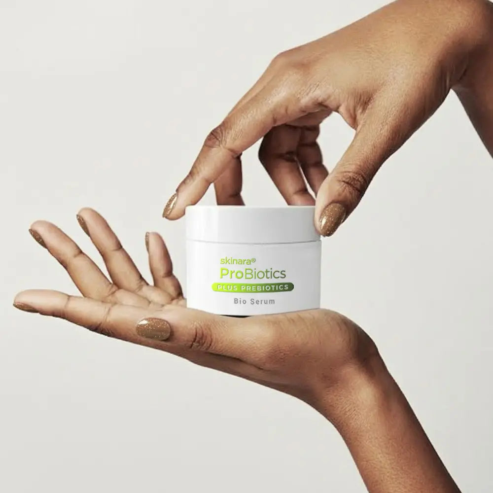 hands holding a Skinara Bio Serum probiotic moisturizer for skin barrier repair