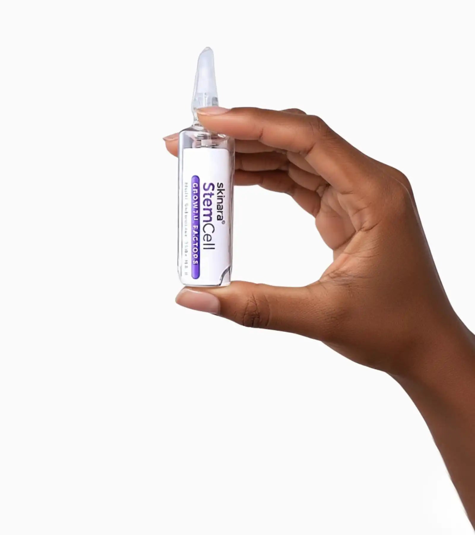 skinara growth factor serum ampoule held in womans fingers