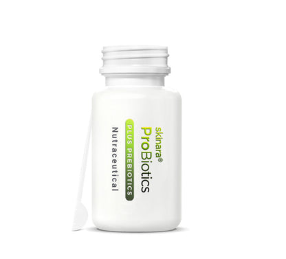 Skinara Probiotic Supplement bottle open with the spatula resting against it on a white background